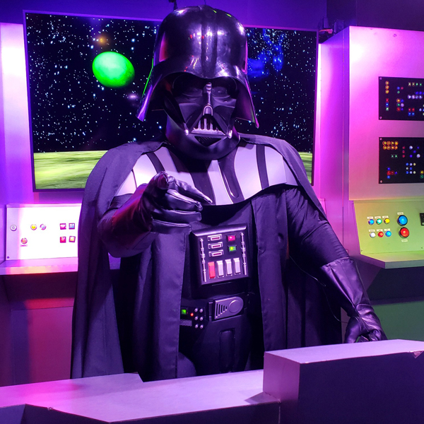 Darth Vadar pointing at the camera before officiating a wedding at the Sci-Fi Wedding Chapel.